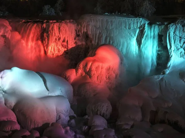 A partially frozen American Falls is seen lit by lights during sub freezing temperatures in Niagara Falls, Ontario. (Photo by Mark Blinch/Reuters)