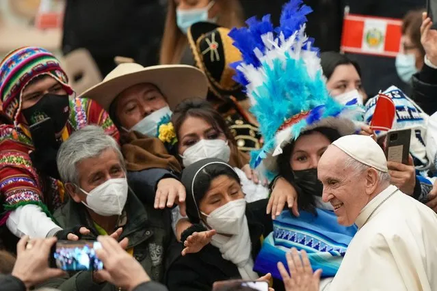 Pope Francis greets delegations from the Huancavelica region of Peru, and from the northern Italian town of Andalo, who respectively donated the nativity scene and Christmas tree that adorn St. Peter's Square, during an audience in the Pope Paul VI hall at the Vatican, Friday, December 10, 2021. (Photo by Andrew Medichini/AP Photo)