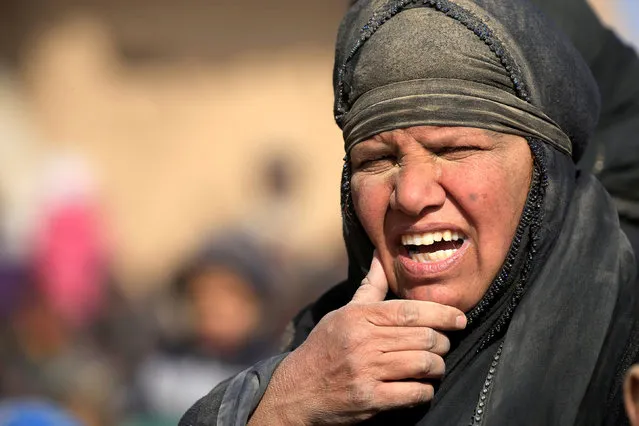 A displaced Iraqi woman, flees her home as Iraqi forces battle with Islamic State militants, in western Mosul, Iraq February 26, 2017. (Photo by Alaa Al-Marjani/Reuters)