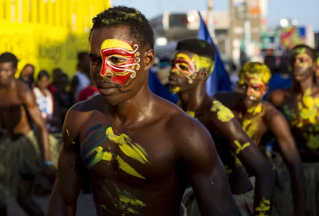 Performers file past in the Carnival parade in Les Cayes, Haiti, Monday, February 27, 2017. Costumed Haitians marched down the city's main avenues, along with drummers who made their skin glisten with oil and crushed charcoal, dancing girls clad in matching outfits and bright head wraps, and shirtless men with intricately painted faces and chests. (Photo by Dieu Nalio Chery/AP Photo)