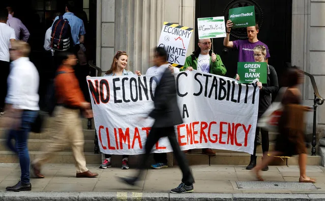 Environmental and banking system protestors demonstrate outside the Bank of England demanding that the bank rule out investment in high-carbon sectors in London, Britain July 11, 2019. (Photo by Peter Nicholls/Reuters)