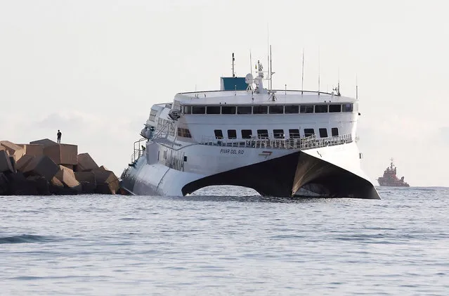 A view of the Balearia company's ferry, Pinar Del Rio, in Denia, Alicante, Spain 17 August 2019 after it ran aground on the breakwater of the port in Denia, on 16 August 2019. A total of 393 passengers where safely evacuated without any reported casualties. (Photo by Juan Carlos Cardenas/EPA/EFE)