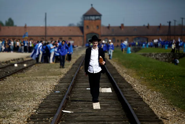 A man walks on the railway tracks in the former Nazi death camp of Auschwitz-Birkenau (Auschwitz II) as thousands of people, mostly youth from all over the world gathered for the annual “March of the Living” to commemorate the Holocaust in Brzezinka near Oswiecim, Poland May 5, 2016. (Photo by Kacper Pempel/Reuters)