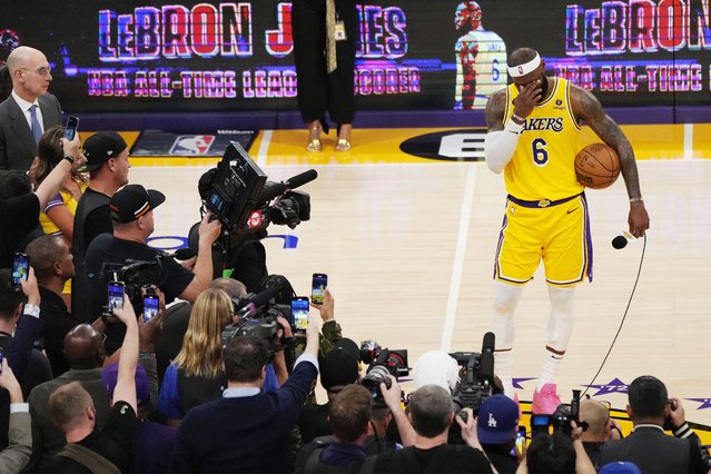 Los Angeles Lakers forward LeBron James (R) stands with his scoring basketball after becoming the all time highest scoring player in NBA history during the second half of the NBA basketball game between the Los Angeles Lakers and Oklahoma City Thunder at the Crypto.com Arena in Los Angeles, California, USA, 07 February 2023. (Photo by Allison Dinner/EPA/EFE)