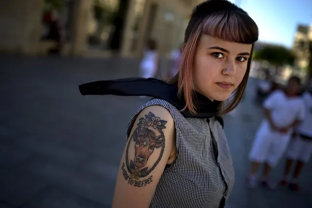 Irene Adan Valiente, 18, spokesperson for animal rights group Accion Antiespecista (Anti Speciesism Action), takes part in an anti bullfighting protest in Pamplona July 9, 2015. Each afternoon for eight days, six bulls are killed by matadors in the bullring during the San Fermin festival. Adan Valiente told Reuters she was protesting because she believed bullfighting had no part in 21st century fiestas. (Photo by Vincent West/Reuters)