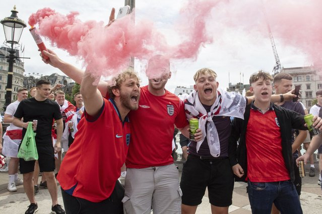 England fans light flares as they enjoy the atmosphere in Trafalgar Square, London, Sunday, July 14, 2024, ahead of the Euro 2024 Final soccer match between Spain and England, being played in Berlin later Sunday.(Photo by Thomas Krych/AP Photo)