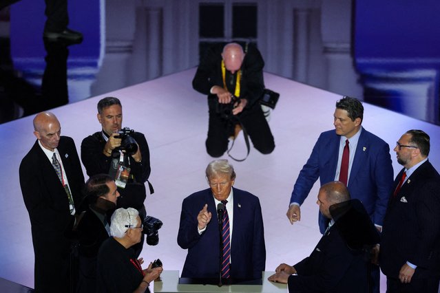 Donald Trump stands with campaign staff during a walk-through ahead of Day 3 of the RNC in Milwaukee on July 17, 2024. (Photo by Andrew Kelly/Reuters)