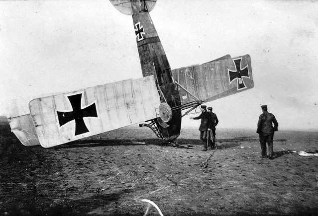 German soldiers attend to an upended German aircraft. (Photo by CC BY SA Carola Eugster via The Atlantic)