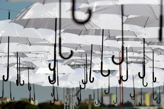 Umbrellas hang as a decoration during Carnaval Sztukmistrzow (Mountebanks) festival in Lublin, Poland, July 22, 205. Picture taken July 22, 2015. (Photo by Jakub Orzechowski/Reuters/Agencja Gazeta)
