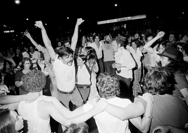 People dance in the streets of Harvard Square in Cambridge, August 9, 1974, following the resignation of Pres. Nixon on television. More than a thousand persons participated in the demonstration. (Photo by Peter Bregg/AP Photo)