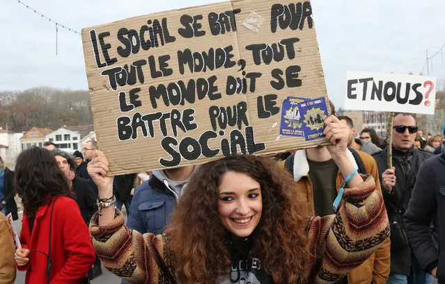 A demonstrator holds a placard reading “The social is fighting for everyone, everyone must fight for the social” in Bayonne, southwestern France, Thursday, December 5, 2019. Transport will be hardest hit by the walkout, with flights, trains and buses canceled and most of the Paris subway system coming to a halt. (Photo by Bob Edme/AP Photo)