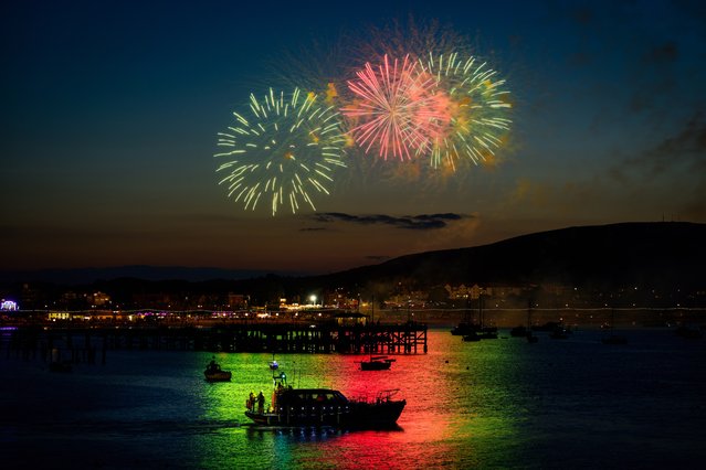 The crew of Swanage lifeboat admire a fireworks display as part of carnival celebrations in the Dorset town, UK on July 29, 2024. (Photo by Andy Lyons/BNPS)