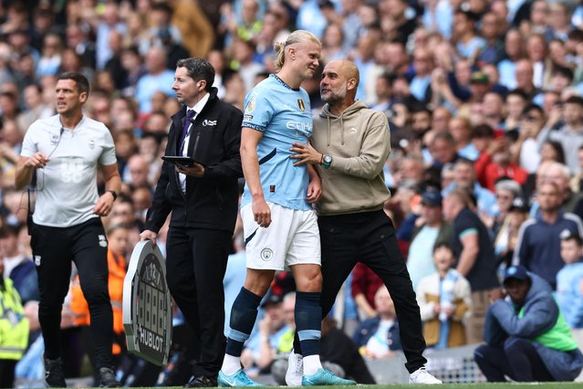 Manchester City's Spanish manager Pep Guardiola (R) speaks with Manchester City's Norwegian striker #09 Erling Haaland (C) as he is substituted during the English Premier League football match between Manchester City and Ipswich Town at the Etihad Stadium in Manchester, north west England, on August 24, 2024. (Photo by Darren Staples/AFP Photo)