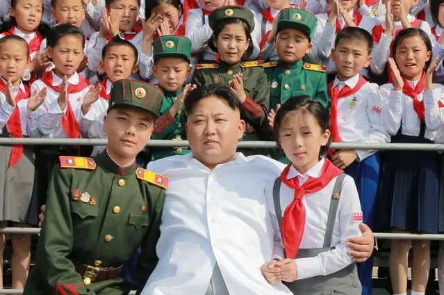 This undated picture released from North Korea's official Korean Central News Agency (KCNA) on June 8, 2016 shows North Korean leader Kim Jong-Un (C) attending a photo session with representatives of the 70th founding anniversary of the Korean Children's Union (KCU) in Pyongyang. (Photo by AFP Photo/KCNA)