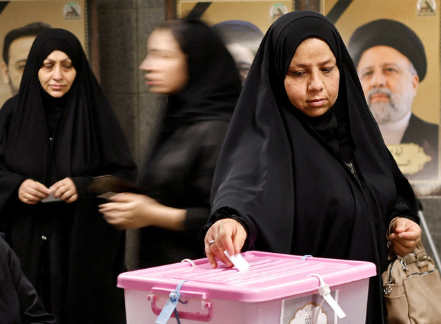 An Iranian voter participates in the run-off presidential election between Masoud Pezeshkian and Saeed Jalili, at the Iranian embassy, in Baghdad, Iraq on July 5, 2024. (Photo by Thaier Al-Sudani/Reuters)