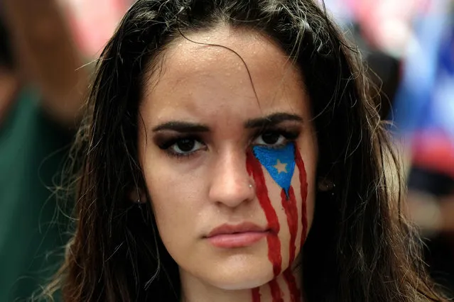 Demonstrators participate in a march the day after the governor of Puerto Rico, Ricardo Rossello resigned from his charge in San Juan, on July 25, 2019. Puerto Rico's embattled governor announced his resignation late July 24, following two weeks of massive protests triggered by the release of a text exchange in which he and others mocked gay people, women and hurricane victims. “I announce that I will be resigning from the governor's post effective Friday, August 2 at 5 pm”, Rossello said, in a video statement posted on the government's Facebook page. (Photo by Ricardo Arduengo/AFP Photo)