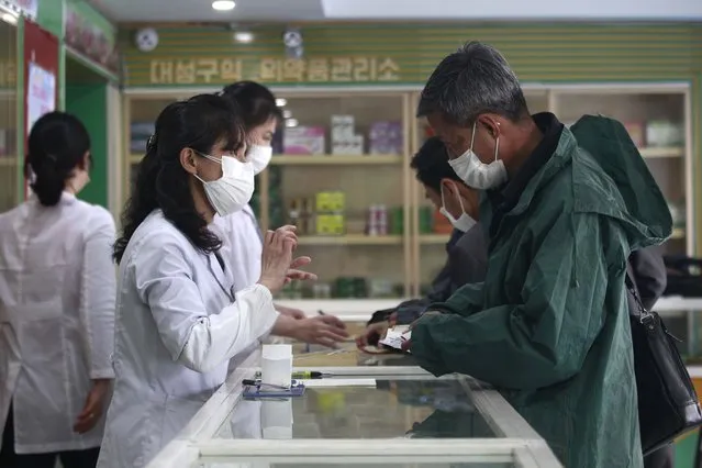 Employees of the Medicament Management Office of the Daesong District in Pyongyang provide medicine to residents as the state increases measures to stop the spread of illness in Pyongyang, North Korea, Monday, May 16, 2022. (Photo by Jon Chol Jin/AP Photo)