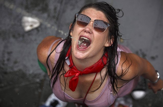 A reveller catches beer thrown from a balcony during the opening day or “Chupinazo” of the San Fermin Running of the Bulls fiesta on July 6, 2017 in Pamplona, Spain. The annual Fiesta de San Fermin, made famous by the 1926 novel of US writer Ernest Hemmingway entitled “The Sun Also Rises”, involves the daily running of the bulls through the historic heart of Pamplona to the bull ring. (Photo by Pablo Blazquez Dominguez/Getty Images)