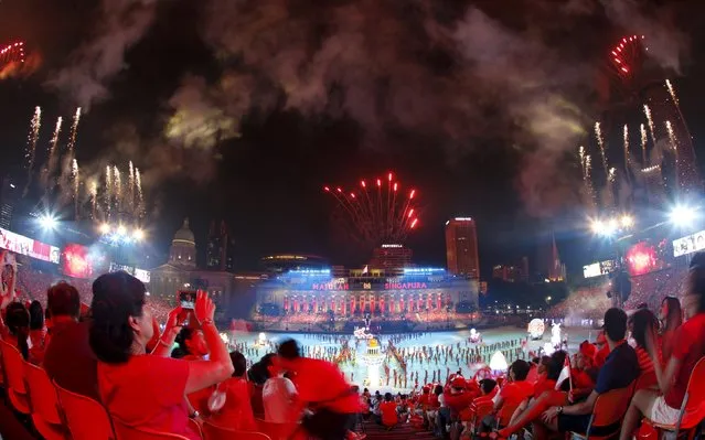 People watch fireworks during Singapore's Golden Jubilee celebrations at the Padang near the central business district August 9, 2015. Singapore marks 50 years of independence on Sunday. An island of 5.5 million people that sits just north of the equator, what was a post-colonial backwater at independence from Malaysia in 1965 is now a global business hub whose economic and social model is the envy of nations around the world. (Photo by Edgar Su/Reuters)