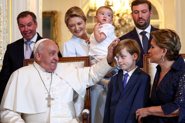 Pope Francis poses for photos with Grand Duchess Maria Teresa of Luxembourg, Hereditary Grand Duke Guillaume of Luxembourg and Hereditary Grand Duchess Stephanie of Luxembourg at the Grand Ducal Palace, during a one-day apostolic journey in Luxembourg, on September 26, 2024. (Photo by Guglielmo Mangiapane/Reuters)