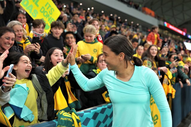 Sam Kerr of Australia high fives with fans after the team's 4-0 victory and qualification for the knockout stage following the FIFA Women's World Cup Australia & New Zealand 2023 Group B match between Canada and Australia at Melbourne Rectangular Stadium on July 31, 2023 in Melbourne / Naarm, Australia. (Photo by Alex Pantling – FIFA/FIFA via Getty Images)