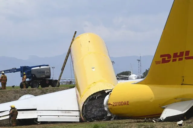 A cargo jet that spun off lays broken on the runway of the Juan Santamaria International Airport in Alajuela, Costa Rica, Thursday, April 7, 2022. According to the fire department, both the pilot and the co-pilot are reported in good health, and accident caused the total closure of the air terminal. (Photo by Carlos Gonzalez/AP Photo)