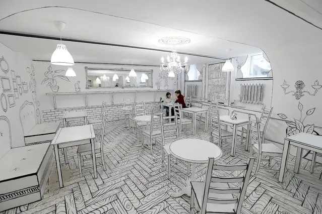 People visit the newly opened “B&W cafe” in the center of St. Petersburg, Russia, 19 February 2020. The interior of the first black-and-white coffee shop to open in Russia looks drawn. This effect was achieved by the creators using white paint and black lines. All repairs and design were done by hand in 35 days. (Photo by Anatoly Maltsev/EPA/EFE)