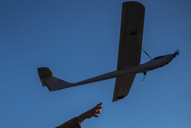 A Ukrainian serviceman of the 12th Azov Special Purpose Brigade of the National Guard of Ukraine launches a Mara reconnaissance unmanned aerial vehicle at a position near the town of Toretsk, amid Russia's attack on Ukraine, in Donetsk region, Ukraine on October 23, 2024. (Photo by Viacheslav Ratynskyi/Reuters)
