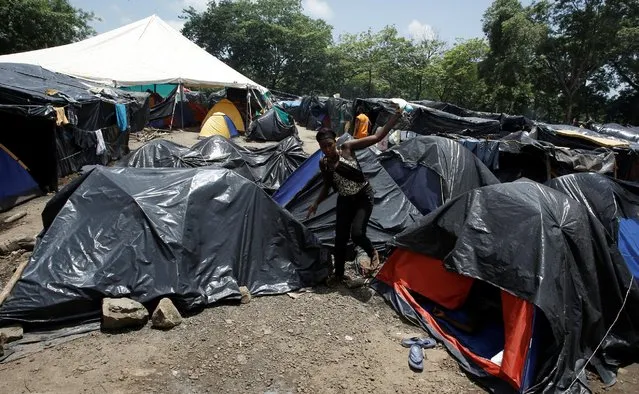 An African migrant stranded in Costa Rica, walks at makeshift camp at the border between Costa Rica and Nicaragua, in Penas Blancas, Costa Rica, July 14, 2016. (Photo by Juan Carlos Ulate/Reuters)
