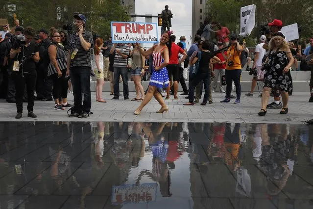 A woman in an American flag-themed outfit protests Republican presidential nominee Donald Trump on Cleveland Public Square on the final day of the Republican National Convention on July 21, 2016, in Cleveland, Ohio. (Photo by Dominick Reuter/AFP Photo)