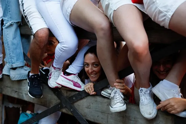 Revellers wait ahead of the running of the bulls at the San Fermin festival in Pamplona, Spain, July 11, 2022. (Photo by Vincent West/Reuters)