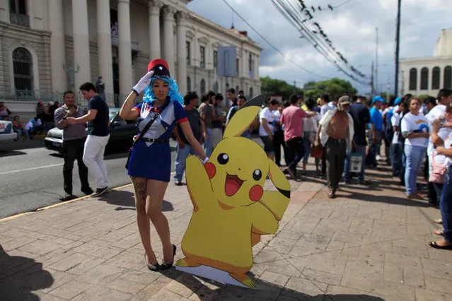 Cosplayer dressed as a character of the augmented reality mobile game “Pokemon Go” by Nintendo participate in a “poketour” organized by the municipality in San Salvador, El Salvador July 23, 2016. (Photo by Jose Cabezas/Reuters)