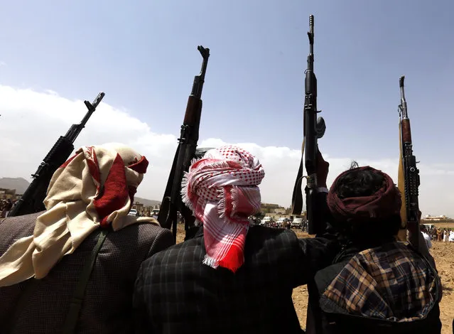 Armed tribesmen, loyal to the Houthi rebels, brandish weapons during a gathering mobilizing more fighters to confront the Saudi-backed Yemeni government forces on the eastern outskirts of Sana'a, Yemen, 19 July 2016. According to reports, Yemen’s Saudi-backed government forces are reportedly mobilizing in the vicinity of the capital Sana’a in preparation for an offensive to seize the rebel-held capital, as UN-sponsored peace talks between Yemen’s warring factions were resumed in Kuwait few days ago, in a fresh attempt to end more than a year of conflict in the troubled Arab country. (Photo by Yahya Arhab/EPA)