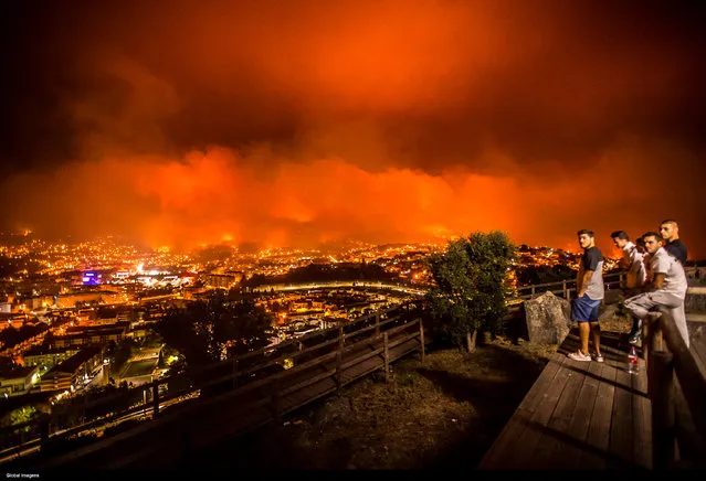 Fires run along a mountainside near Braga, Portugal on October 15, 2017. Wild fires have broken out in Santa Marta, Sameiro, Taipas and Braga. (Photo by Goncalo Delgado/Global Images/Sipa USA/Barcroft Images)