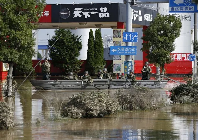 Japanese Self-Defence Force soldiers on a boat conduct a rescue operation at a residential area flooded by the Kinugawa river, caused by typhoon Etau, at Araigi town in Joso, Ibaraki prefecture, Japan, September 12, 2015. (Photo by Issei Kato/Reuters)