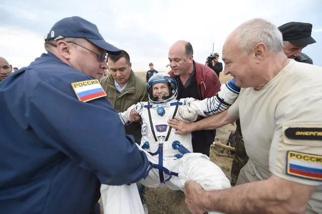 Ground personnel carry Denmark's astronaut Andreas Mogensen after landing near the town of Dzhezkazgan (Zhezkazgan), Kazakhstan, in this September 12, 2015 handout picture. (Photo by Stephane Corvaja/Reuters/ESA)