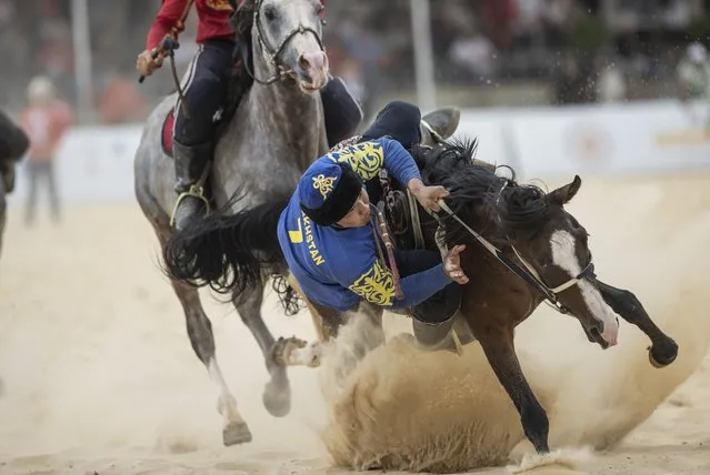 Horse riders of Kazakhstan and Kyrgyzstan compete during the final match of Kokboru competition within the 4th World Nomad Games held under the leadership of the World Ethnosport Confederation at lakeside town of Iznik, in Bursa, Turkiye on October 02, 2022. (Photo by Emin Sansar/Anadolu Agency via Getty Images)