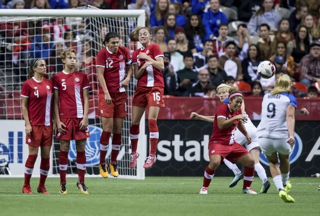 United States' Lindsey Horan (9) takes a free kick as Canada's Shelina Zadorsky, Rebecca Quinn, Christine Sinclair, Janine Beckie and Desiree Scott, from left, defend during the first half of an international friendly soccer match, Thursday, November 9, 2017, in Vancouver, British Columbia. (Photo by Darryl Dyck/The Canadian Press via AP Photo)