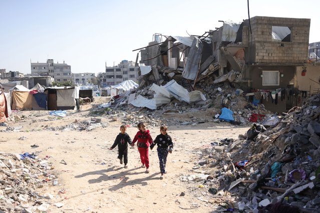 Palestinian children play amid rubble in Jabalya, Gaza, on Monday, February 17, 2025. (Photo by Bashar Taleb/AFP Photo)