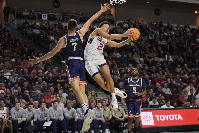 Saint Mary's guard Jordan Ross (2) shoots around Pepperdine forward Stefan Todorovic (7) during the second half of an NCAA college basketball game in the semifinals of the West Coast Conference men's tournament Monday, March 10, 2025, in Las Vegas. (Photo by John Locher/AP Photo)
