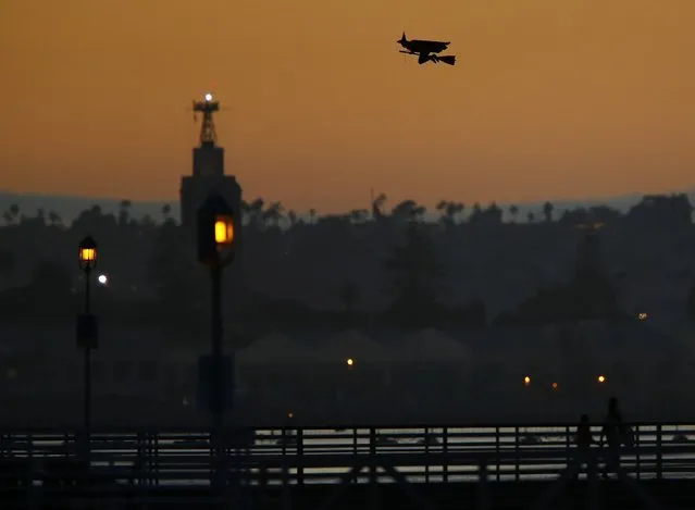 A radio-controlled flying witch travels across the ocean waters of Coronado, California October 7, 2014. (Photo by Mike Blake/Reuters)
