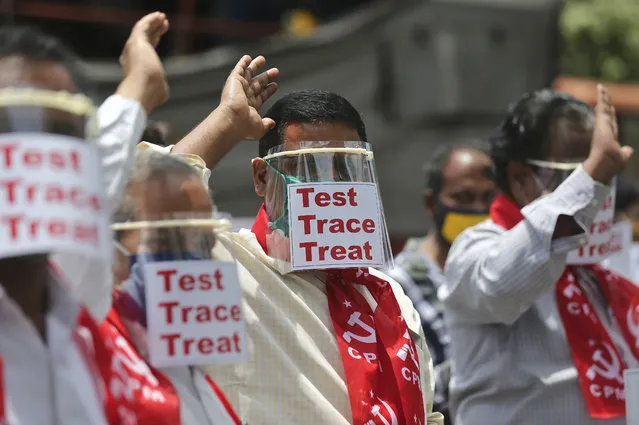 Activists of Communist Party of India Marxist display placards on face shields and shout slogans during a protest asking the state government to increase testing and free treatment for all COVID-19 patients in Hyderabad, India, Monday, June 29, 2020. Governments are stepping up testing and warily considering their next moves as the number of newly confirmed coronavirus cases surges in many countries. India reported more than 20,000 new infections on Monday. (Photo by Mahesh Kumar A./AP Photo)