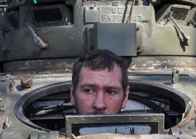 A Ukrainian serviceman looks out from a Bradley Fighting Vehicle (BFV), as Russia's attack on Ukraine continues, near the town of Izium, recently liberated by Ukrainian Armed Forces, in Kharkiv region, Ukraine on September 19, 2022. (Photo by Gleb Garanich/Reuters)