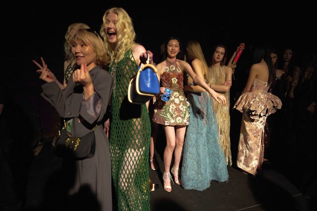 Models wait backstage before the Movous Couture show during China Fashion Week in Beijing, Friday, March 21, 2025. (Photo by Ng Han Guan/AP Photo)