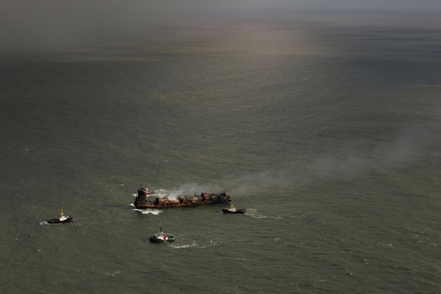 Smoke billows from the MV Solong cargo ship off the Yorkshire coast in the North Sea, Britain, 11 March 2025. Thirty-six people were reportedly brought ashore, and one taken to hospital, after the collision of the oil tanker Stena Immaculate and the Solong, a cargo vessel, off the East Yorkshire coast on 10 March 2025 morning. The coastguard has said a search has been called off for one missing crew member of the Solong. (Photo by Dan Kitwood/EPA/EFE)