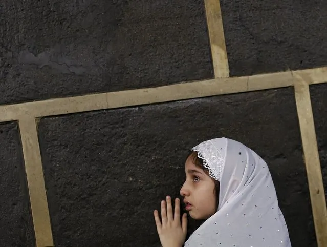 A Muslim girl touches the holy Kaaba at the Grand Mosque on the first day of Eid al-Adha  during the annual haj pilgrimage in Mecca September 24, 2015. (Photo by Ahmad Masood/Reuters)
