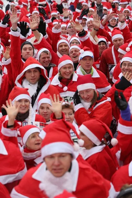 Participants dressed as Santa Claus gather shortly before the 4th annual Michendorf Santa Run (Michendorfer Nikolauslauf) on December 9, 2012 in Michendorf, Germany. Over 800 people took part in this year's races that included children's and adults' races.  (Photo by Sean Gallup)