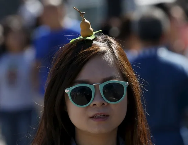 A woman wearing a calabash-like hairpin makes her way in Beijing, China, September 25, 2015. (Photo by Kim Kyung-Hoon/Reuters)