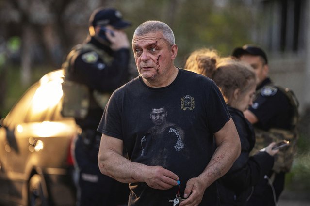 An injured man walks at the site of a Russian missile attack in a residential area, amid Russia's attack on Ukraine, in Kharkiv, Ukraine, on April 18, 2025. (Photo by Marko Djurica/Reuters)
