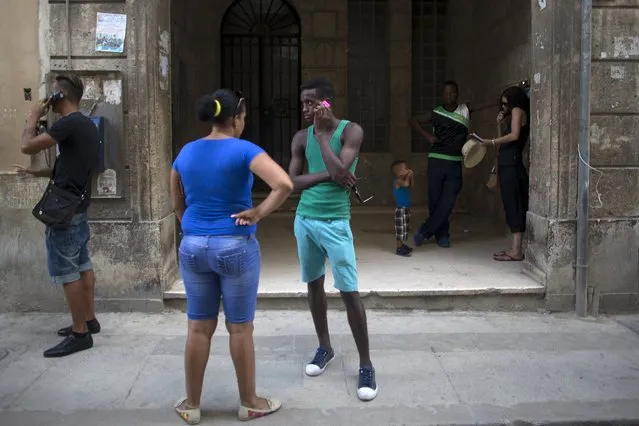 People use telephones in Havana, September 18, 2015. (Photo by Alexandre Meneghini/Reuters)